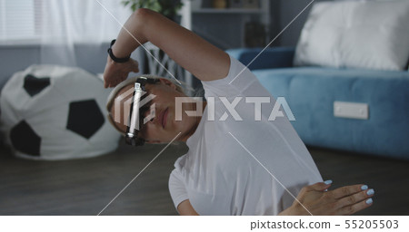 Woman working out at home with VR headset 55205503