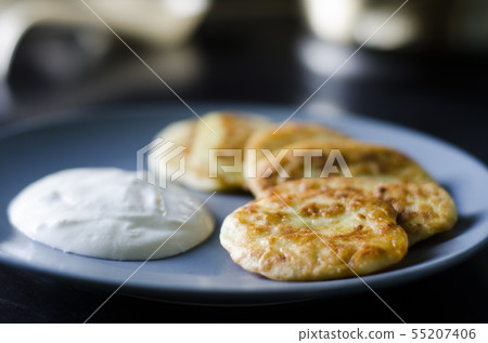Pancakes with zucchini vegetable and sour cream. Pancakes with zucchini vegetable and sour cream. 55207406