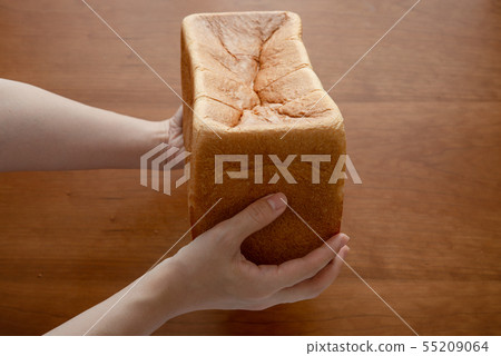 Woman hand holding bread 55209064