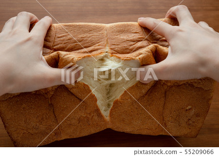Breaking a loaf of bread 55209066
