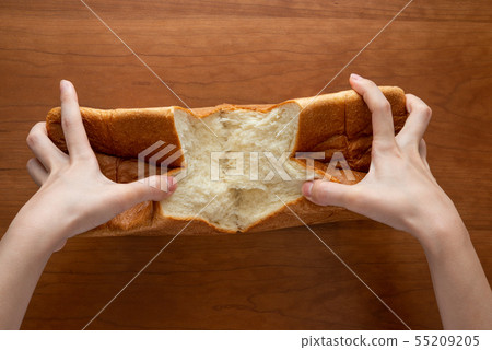 Breaking a loaf of bread 55209205