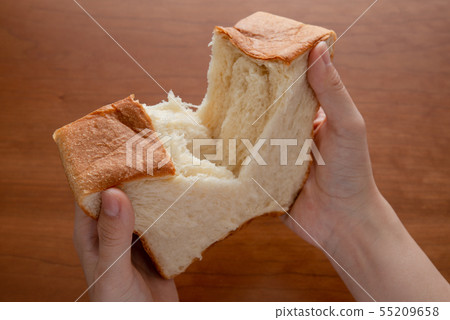 State that tears bread with a woman hand 55209658