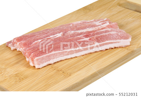 Raw bacon on the board. 55212031