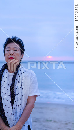 Asian senior standing alone and thinking at Asian senior standing alone and thinking at 55212848