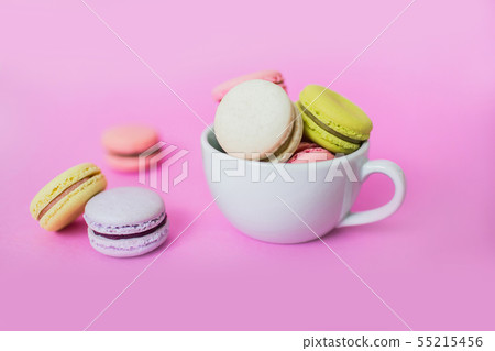 Macaroon or macaron biscuits in mug on pink background. 55215456