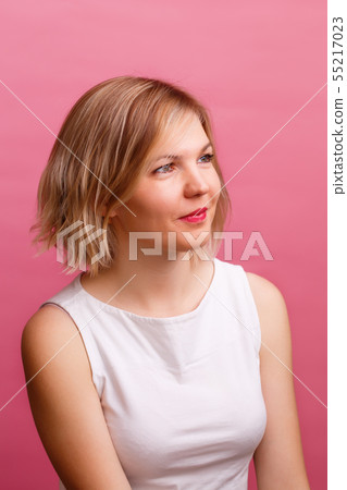 Photo of blonde in white T-shirt looking at camera Photo of blonde in white T-shirt looking at camera 55217023