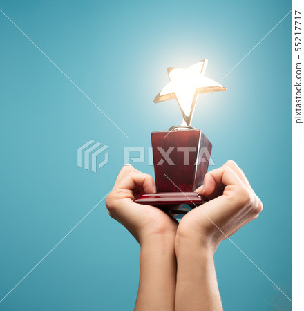 Photo of hands of man raising goblet with star Photo of hands of man raising goblet with star 55217717