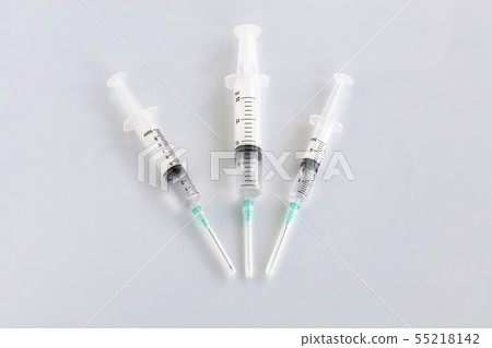 Several different syringes on a white smooth table 55218142