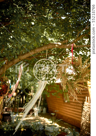 Dreamcatcher of light fabric with beads develops in the wind.Relax, children's dreams. garden of Dreamcatcher of light fabric with beads develops in the wind.Relax, children's dreams. garden of 55218766