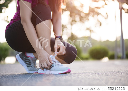 Running shoes - closeup of woman tying shoe laces. 55219223