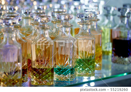 Glass perfume bottles based oils.A Bazaar, market.Aroma oils, oil perfume in faceted glass vessels. Glass perfume bottles based oils.A Bazaar, market.Aroma oils, oil perfume in faceted glass vessels. 55219260