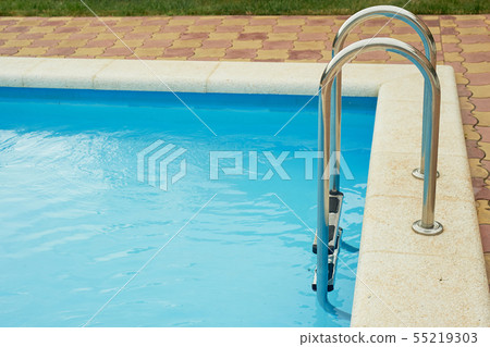 Metal handrails in the pool.The descent into the water. Vacation, rest and relaxation Metal handrails in the pool.The descent into the water. Vacation, rest and relaxation 55219303