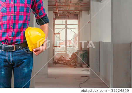 engineering hand holding helmet yellow safety. engineering hand holding helmet yellow safety. 55224869