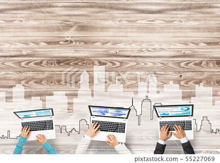 Top view of businesspeople sitting at table and using gadgets Top view of businesspeople sitting at table and using gadgets 55227069