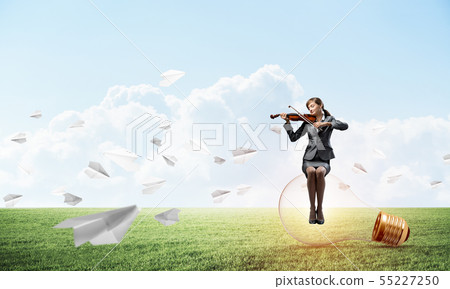 Young woman with violin sitting on glowing lamp Young woman with violin sitting on glowing lamp 55227250