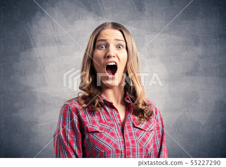 Scared young woman screaming with panic Scared young woman screaming with panic 55227290