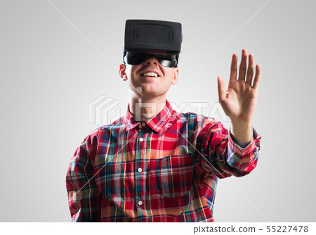Guy in mask experiencing virtual reality as new entertainment device 55227478
