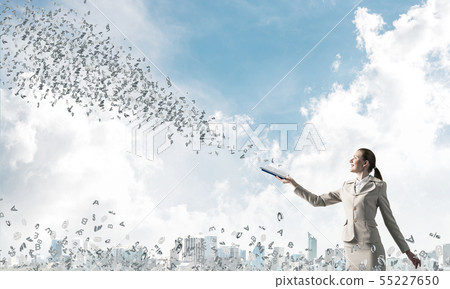 Smiling woman looking at flying out random letters 55227650