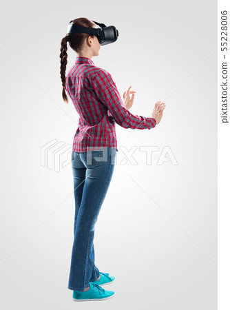 Young woman wearing VR goggles 55228006