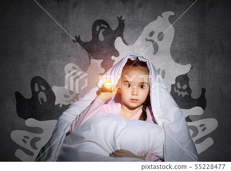 Surprised girl hiding under blanket 55228477