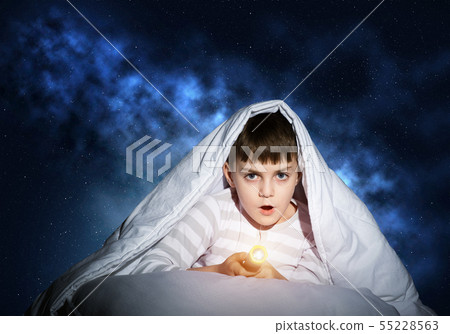 Surprised child hiding under blanket 55228563