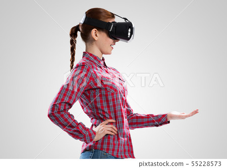 Girl in mask experiencing virtual reality as new entertainment device Girl in mask experiencing virtual reality as new entertainment device 55228573