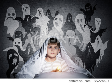 Little child with flashlight hiding under blanket Little child with flashlight hiding under blanket 55228804