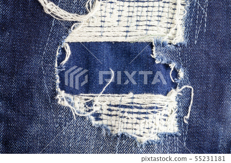 Blue torn denim jeans texture background. Blue torn denim jeans texture background. 55231181