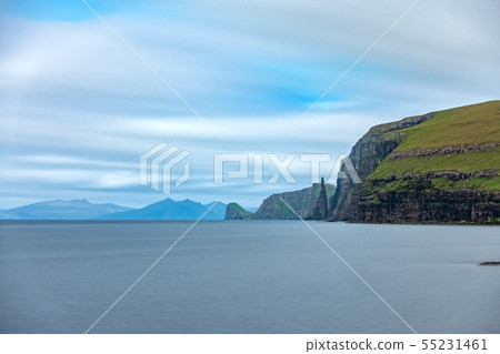 Sandoy rock needle in the steep coastline, long exposure 55231461