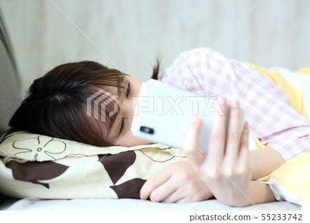 Image of woman operating smartphone with bet Image of woman operating smartphone with bet 55233742