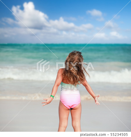 Happy blond baby girl on the ocean coast Happy blond baby girl on the ocean coast 55234505