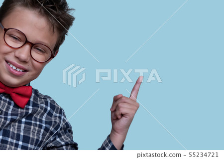 Young schoolchild pointing up portrait Young schoolchild pointing up portrait 55234721