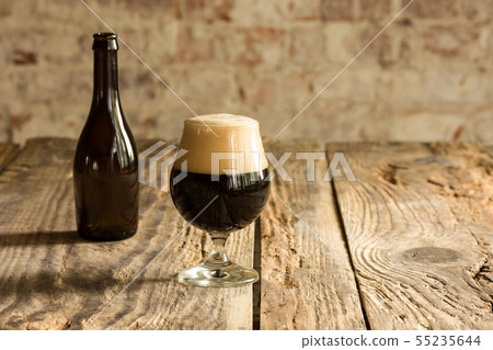 Glasses of different kinds of beer on wooden background Glasses of different kinds of beer on wooden background 55235644