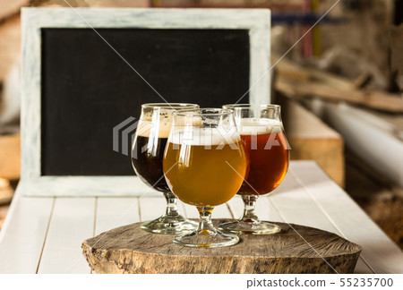 Glasses of different kinds of beer on wooden background Glasses of different kinds of beer on wooden background 55235700