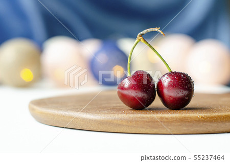 Ripe cherry close-up. Cherry sisters. Bokeh. Wood Ripe cherry close-up. Cherry sisters. Bokeh. Wood 55237464