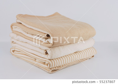 Closeup pile wrapped folded natural beige cotton Closeup pile wrapped folded natural beige cotton 55237807