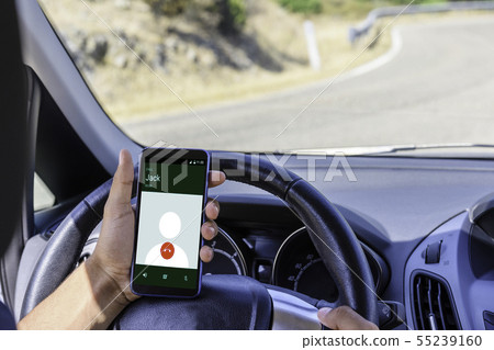 Young driver, using smartphone, on the road. Young driver, using smartphone, on the road. 55239160