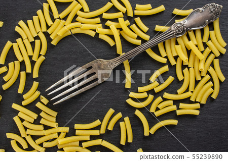 Raw macaroni pasta on grey stone 55239890