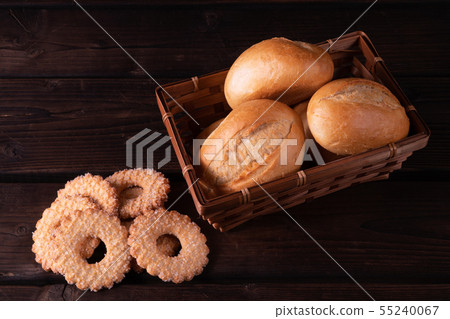 Home made cookies and buns in bread basket on a 55240067