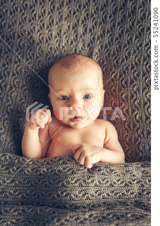 Funny portrait of a full face newborn, lying in a crib, hand raised up. Voting Funny portrait of a full face newborn, lying in a crib, hand raised up. Voting 55241090