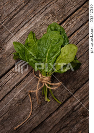 bunch of spinach on wooden background Top view bunch of spinach on wooden background Top view 55242550