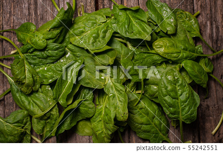 spinach on a wooden background with drops. Top view spinach on a wooden background with drops. Top view 55242551