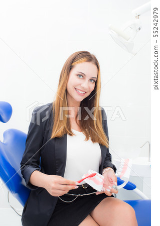 young woman showing how to clean your teeth 55242979