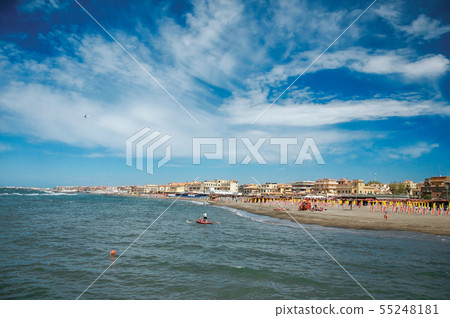 Man paddling a rescue boat near the beach of Ostia Man paddling a rescue boat near the beach of Ostia 55248181