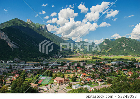 Houses in valley with green mountains and blue sky Houses in valley with green mountains and blue sky 55249058