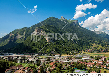Houses in valley with green mountains and blue sky Houses in valley with green mountains and blue sky 55249060