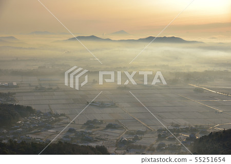 Sunrise from the east side of the big and small mountain peaks The morning sun with the morning misting snowfall The countryside and far distance Mt. Mitaka and Mt. Tsukuba 55251654