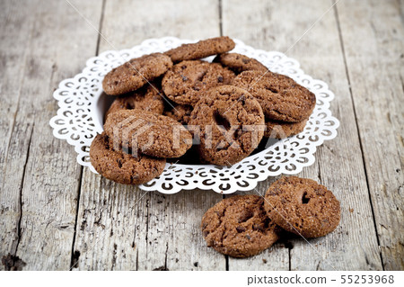 Fresh baked chocolate chip cookies heap on white 55253968