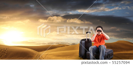 boy with suitcases and binocular in a desert 55257094