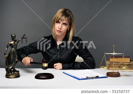 A young fair woman judge works in her office. 55258737